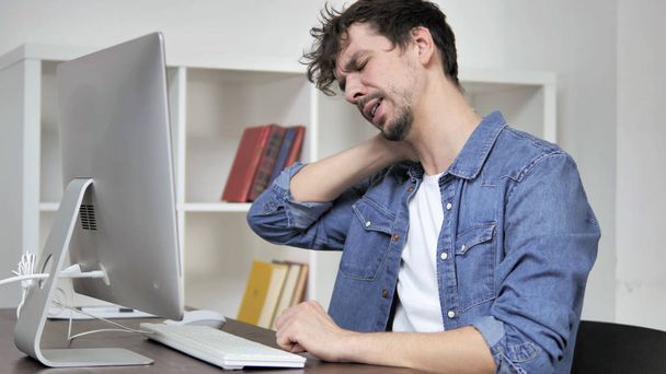 Tired Man with Neck Pain Working on Desktop - Fotó, kép