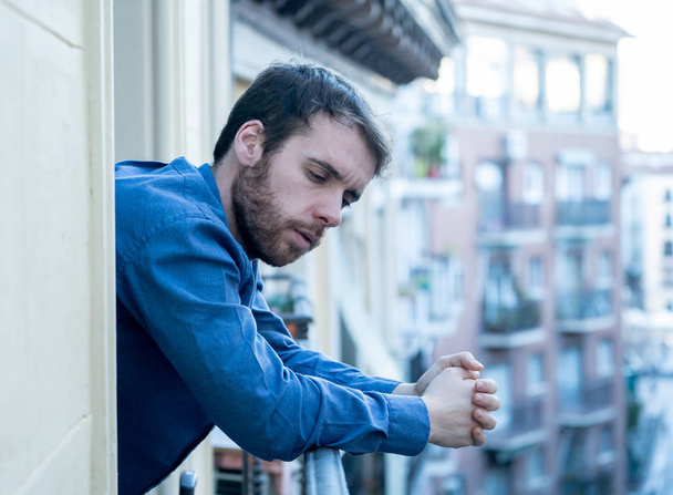Lonely sad man staring outside house balcony feeling depressed distress and miserable. Suffering emotional crisis thinking about difficult important life decision In Men Depression and mental health. - Foto, Bild