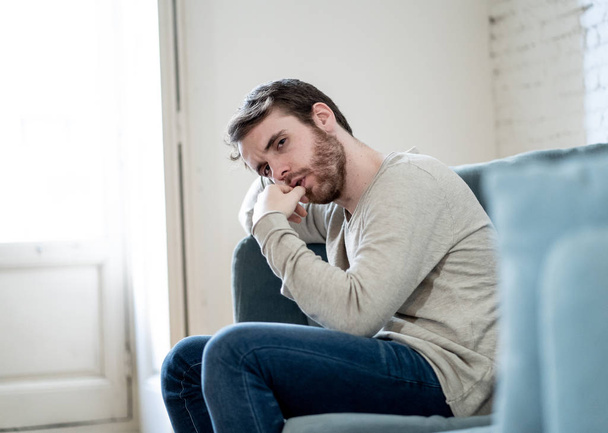 Unhappy depressed caucasian male sitting and lying in living room couch feeling desperate a lonely suffering from depression. In stressed from work, anxiety, heartbroken and men Health care concept. - Fotoğraf, Görsel