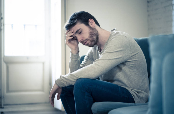 Unhappy depressed caucasian male sitting and lying in living room couch feeling desperate a lonely suffering from depression. In stressed from work, anxiety, heartbroken and men Health care concept. - Foto, imagen