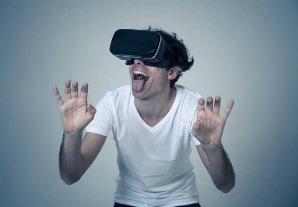 Amazed funny man using VR headset glasses touching and interacting with virtual reality world , feeling excited exploring and having fun in 360 VR simulation. Innovation and new technology concept. - Photo, Image
