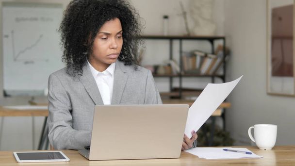 African Businesswoman Doing Paperwork in Office - Photo, Image