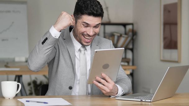 Businessman Celebrating Success while Using Tablet - Photo, Image