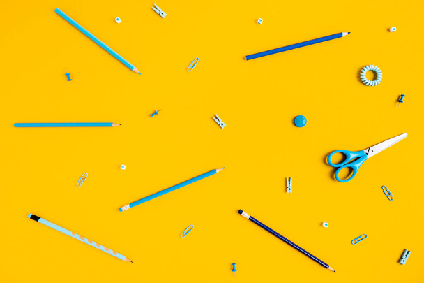 Yellow background with pens and pencils for school advertising. - Foto, imagen