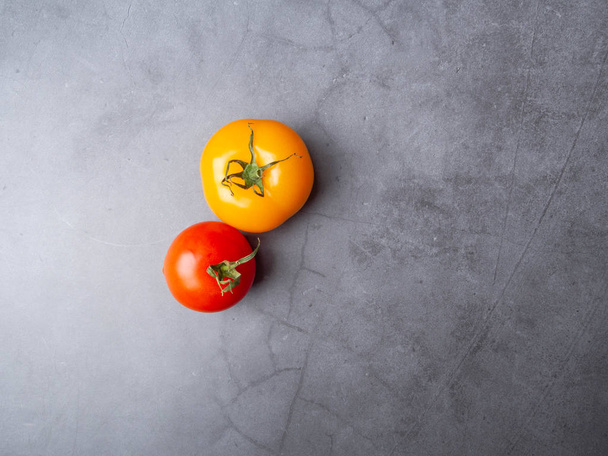 ripe tomatoes on grey background with copy space - Φωτογραφία, εικόνα