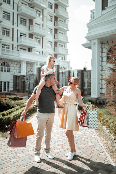 Married couple and their child going home after shopping. - Valokuva, kuva