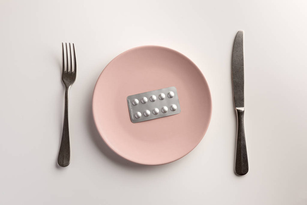 Blister with pills on the plate. Flat lay. - Foto, imagen