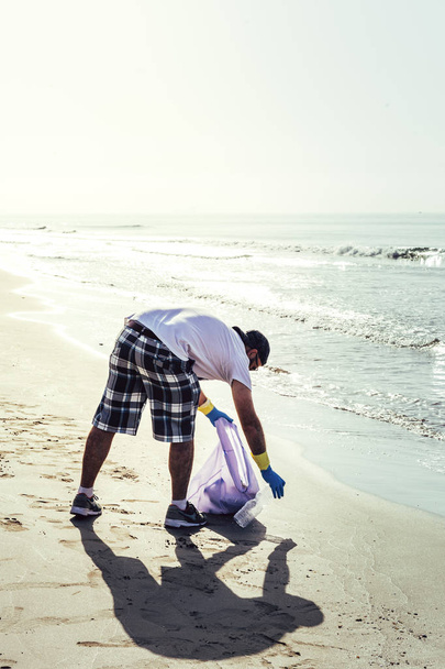 volunteer collecting waste that pollute the sea - Photo, Image