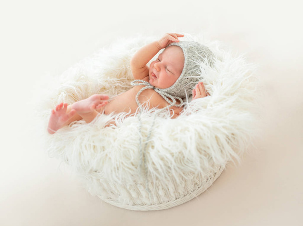 Cute newborn boy lying in a basket - Foto, Imagem