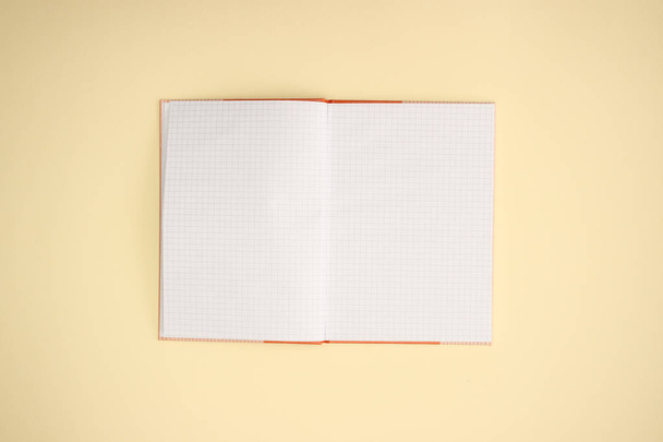Open notebook on yellow background  - Zdjęcie, obraz
