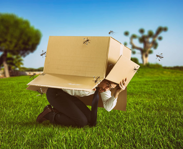 Člověk se brání útoku komárů skrývající se v kartonové krabici - Fotografie, Obrázek