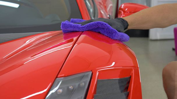 Professionals wear Chemical protective clothing at work.Car Care Business. Automobile industry. Car wash and coating business with ceramic coating.Spraying the varnish to the car. - Fotó, kép