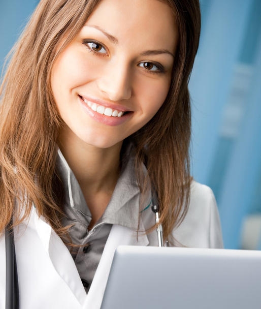 Cheerful female doctor with laptop - Foto, Imagem