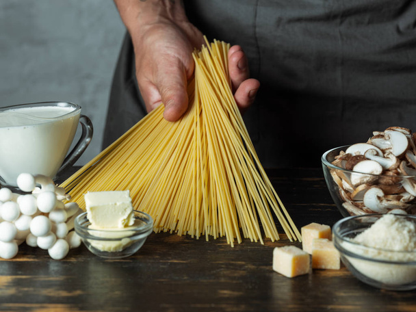 Close view of raw ingredients for italian pasta with parmesan cheese and mushroom sauce - Фото, изображение