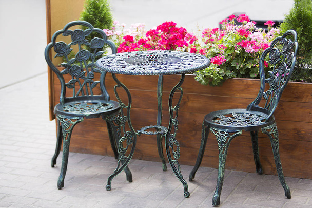 wrought iron table and chairs in the garden - Photo, Image