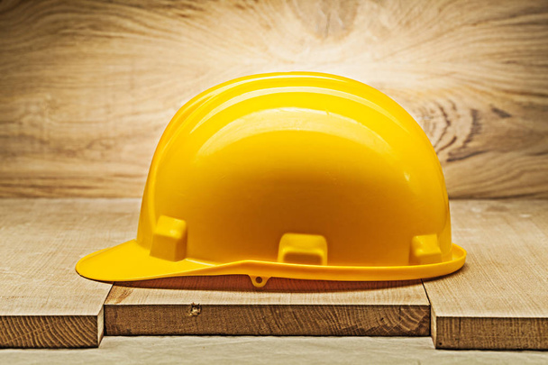 yellow construction helmet on wood background - Φωτογραφία, εικόνα