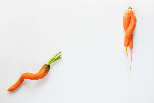 Ugly carrots on a white background. Ugly food concept, flat lay. - Foto, Imagem