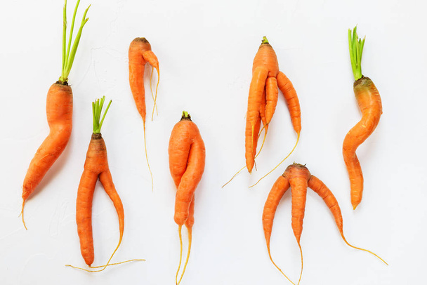 Ugly carrots on a white background. Ugly food concept, flat lay. - Фото, зображення