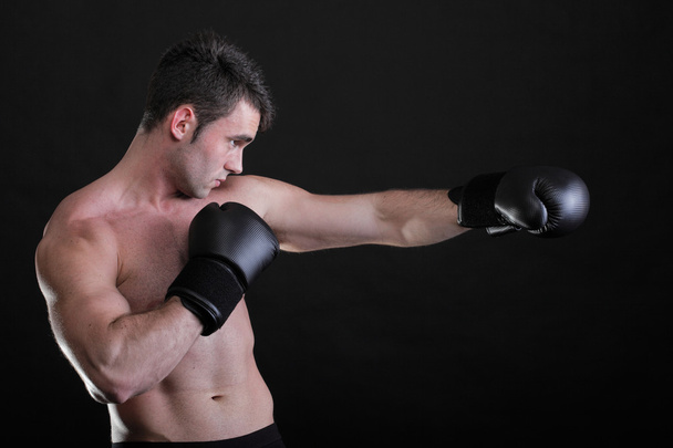 Portrait sportsman boxer in studio dark background - Zdjęcie, obraz