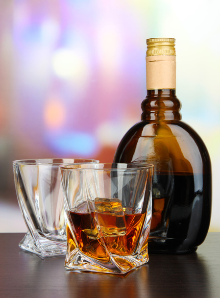 Glass of liquor with bottle, on dark background - Foto, Imagem