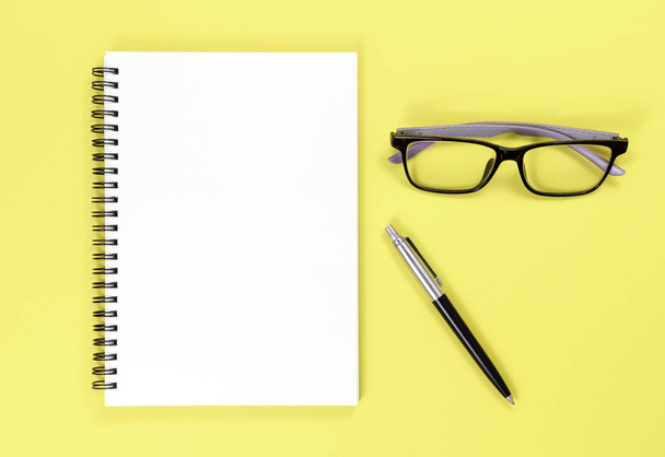 Mock up notebook, pen and glasses on colorful background with copy space.view from above - Foto, imagen