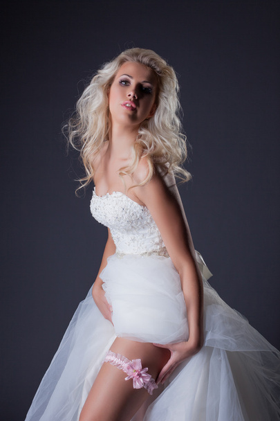 Seductive blonde posing in chic wedding dress - Foto, Imagen