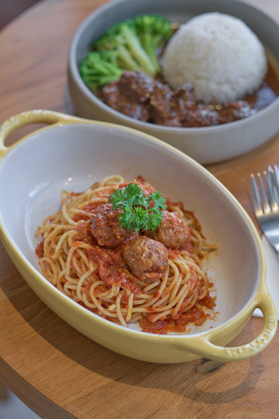 Spaghetti meatballs with tomato sauce in yellow bowl. - Photo, image