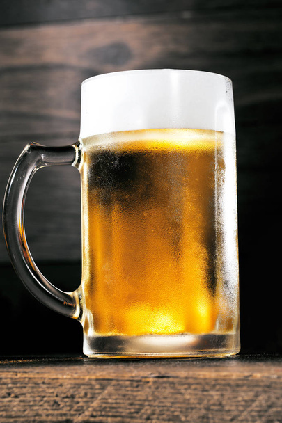 close-up view of glass of beer on wooden background - Φωτογραφία, εικόνα