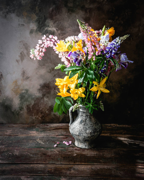 Colorful summer bouquet with lilies, lupine flowers, bell-flowers and dandelions in old vase on concrete background  - Foto, Bild