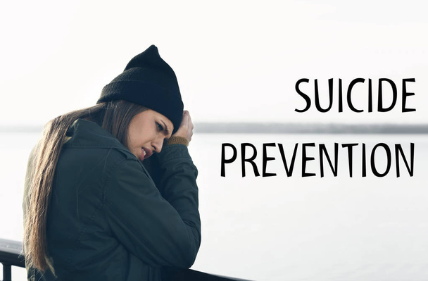 Young depressed woman on bridge. Suicide prevention concept - Photo, Image