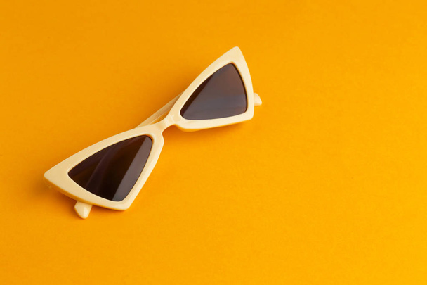 Modern sunglasses on color background - Foto, afbeelding