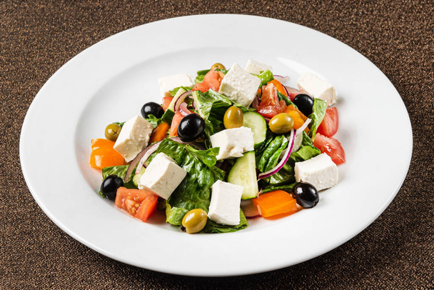 greek salad on the white plate, close up - Fotó, kép