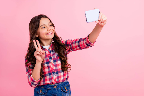 Porrait of cute attractive lovely kid make photo video call live blog blogger positive cheerful excited fun rest relax stylish modern checked shirt over pink background - Φωτογραφία, εικόνα