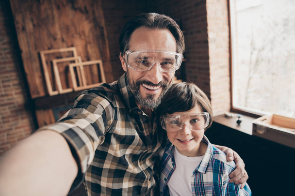 Close up photo pretty cute charming people person professional make photo video call live influencer home garage brunet hair workstation shirt stylish industrial interior glasses goggles protective - 写真・画像