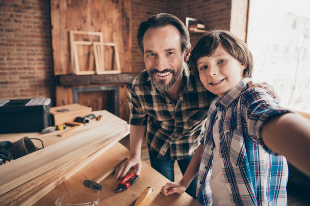 Self-portrait of two nice person cheerful cheery woodworkers handymen generation creating construction at school course class studio modern loft industrial brick interior indoors - 写真・画像