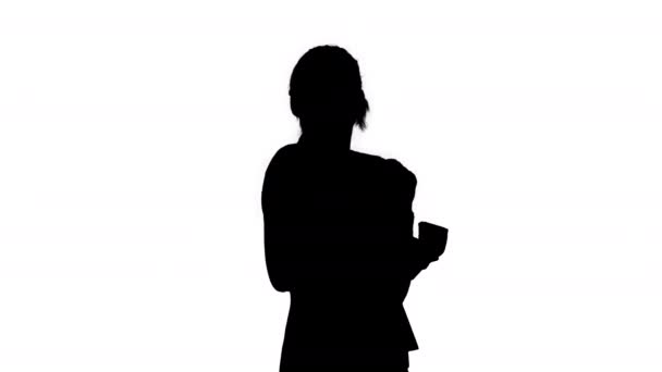 Silhouette Confident and happy young businesswoman putting money in her pocket and dancing after this . - Footage, Video