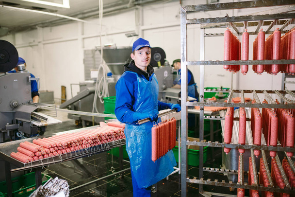Portret rzeźników przetwarzania kiełbasy w fabryce mięsa - Zdjęcie, obraz