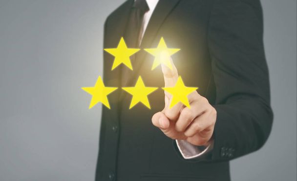 Hand touching five star symbol to increase rating  - Photo, Image