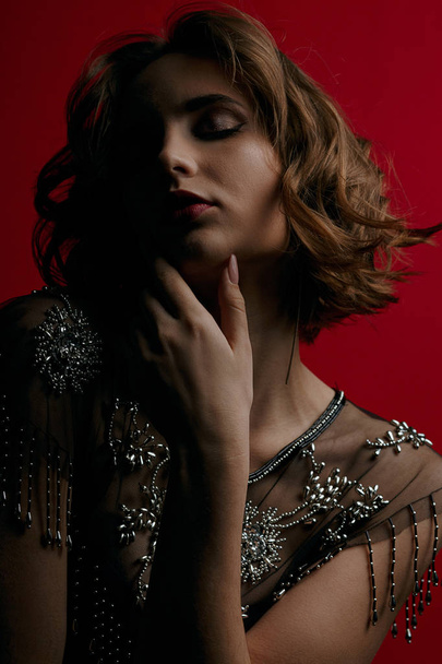 Tender brunette model with curly hair posing with contrast light - Foto, Imagem