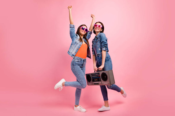 Full length side profile body size photo beautiful she her best ladies festive mood hands arms raised listen playlist vintage recorder wear jeans denim jackets blazers isolated bright pink background - Fotó, kép
