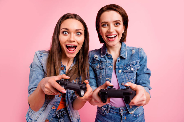 Close up photo beautiful buddies she her best ladies chill mood hands arms watch screen win winner victory video gamers competition wear jeans denim jackets blazers isolated bright pink background - Фото, зображення