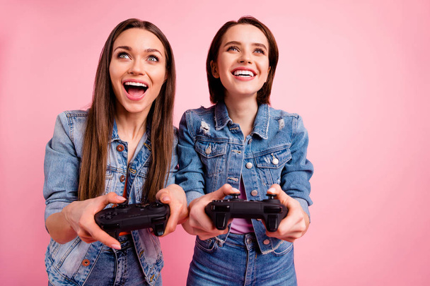 Close up photo beautiful buddies she her best ladies chill mood hands arms watch screen win winner victory video gamers competition wear jeans denim jackets blazers isolated bright pink background - Valokuva, kuva