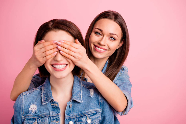 Close up photo two beautiful she her sisters ladies hide eyes hands arms try guess who unexpected meeting best buddies glad see fellows wear jeans denim jackets blazers isolated bright pink background - Photo, Image