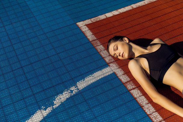 Woman Feeling Tired After Running Outdoors. Sad Exhausted Disappointed Female Athlete In Sportswear Sitting On Ground After Losing Sports Competition, Feeling Pain In Injured Leg. High Resolution. - Fotó, kép