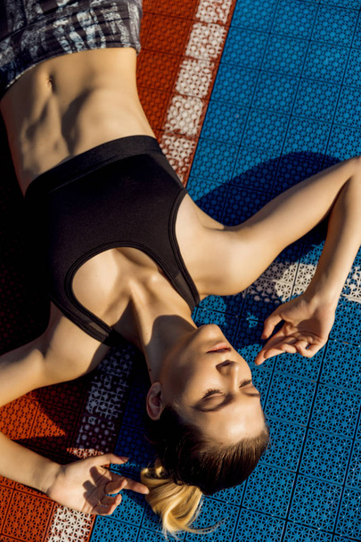 Woman Feeling Tired After Running Outdoors. Sad Exhausted Disappointed Female Athlete In Sportswear Sitting On Ground After Losing Sports Competition, Feeling Pain In Injured Leg. High Resolution. - 写真・画像