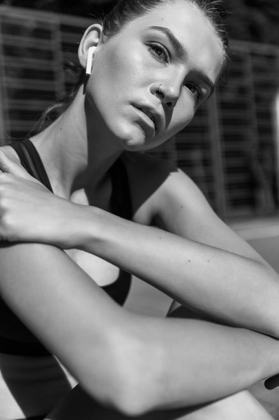 Woman Feeling Tired After Running Outdoors. Sad Exhausted Disappointed Female Athlete In Sportswear Sitting On Ground After Losing Sports Competition, Feeling Pain In Injured Leg. High Resolution. - Foto, Bild