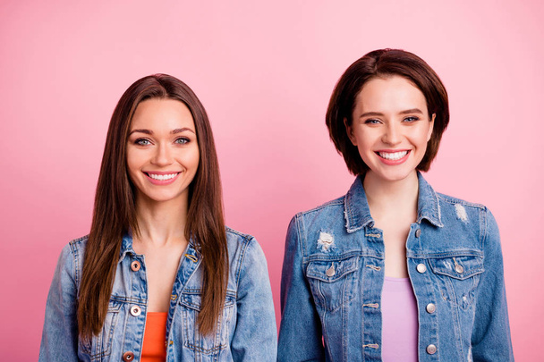 Close up photo two people beautiful amazing funny funky she her ladies perfect teeth pretty appearance white teeth party chill mood wear jeans denim jackets blazers isolated bright pink background - Fotó, kép