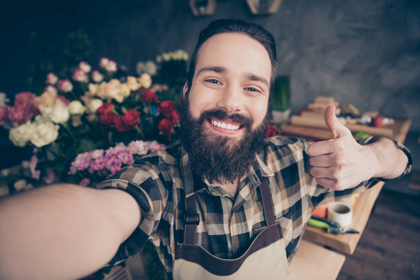 Self-portrait of his he nice attractive content cheerful glad positive guy enjoying life showing thumbup cool good wearing checked shirt at modern industrial loft concrete style workplace workstation - Φωτογραφία, εικόνα