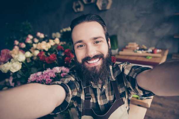 Self-portrait of his he nice attractive cheerful cheery glad positive guy enjoying beautiful place wearing checked shirt at modern industrial loft concrete style salon indoors - Фото, изображение
