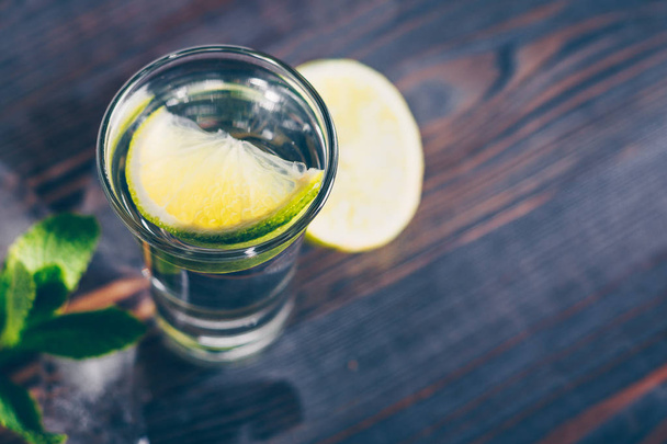 Alcoholic still-life, vodka, gin, tequila in a glass with ice - Zdjęcie, obraz